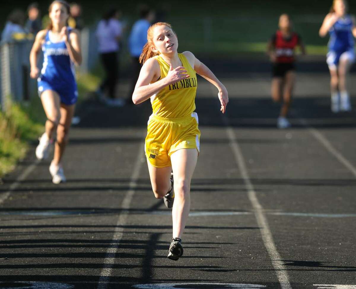 Trumbull's Emily Riehl eyes the finish line on her way to victory in the 400 meters during Monday's track meet versus Fairfield Ludlowe and Bridgeport Central at Trumbull High School.