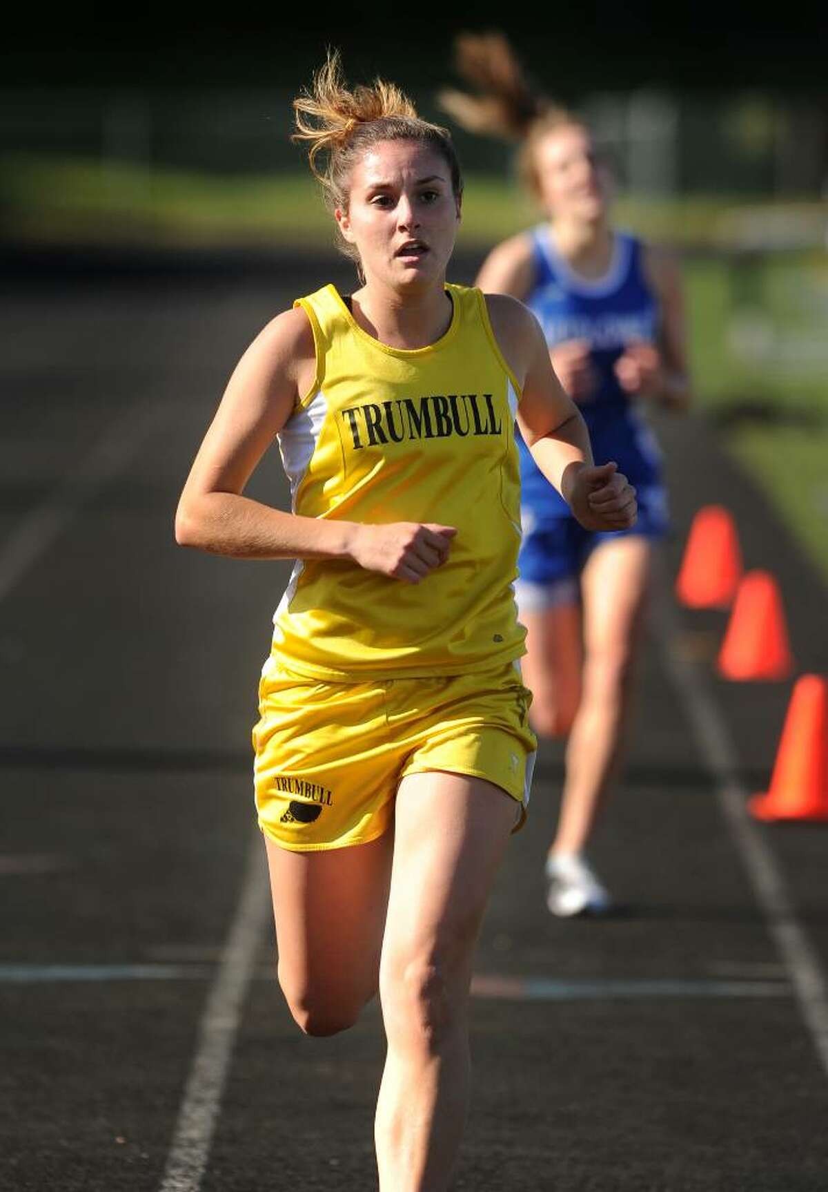 Trumbull's Danielle Klein races to victory over Fairfield Ludlowe's Heather Moriarty in the 1600 meters during Monday's track meet at Trumbull High School.