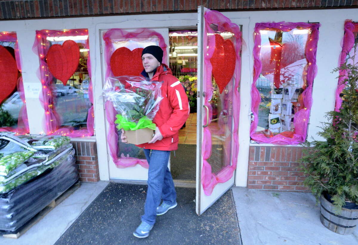 Joe Vitti of Stamford leaves the Springdale Florist & Greenhouses in Stamford on Feb. 12, 2016 after picking up roses for his sweetheart, Amy Moschos of Stamford. Vitti was giving her an early Valentine's Day surprise.