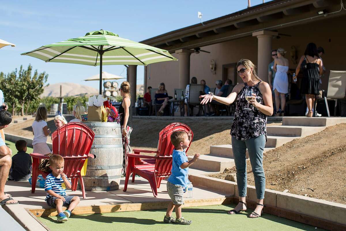Heather Sakai plays bocce ball with her sons while attending a birthday party at McGrail Vineyards in Livermore, Calif., on Saturday, October 8, 2016.