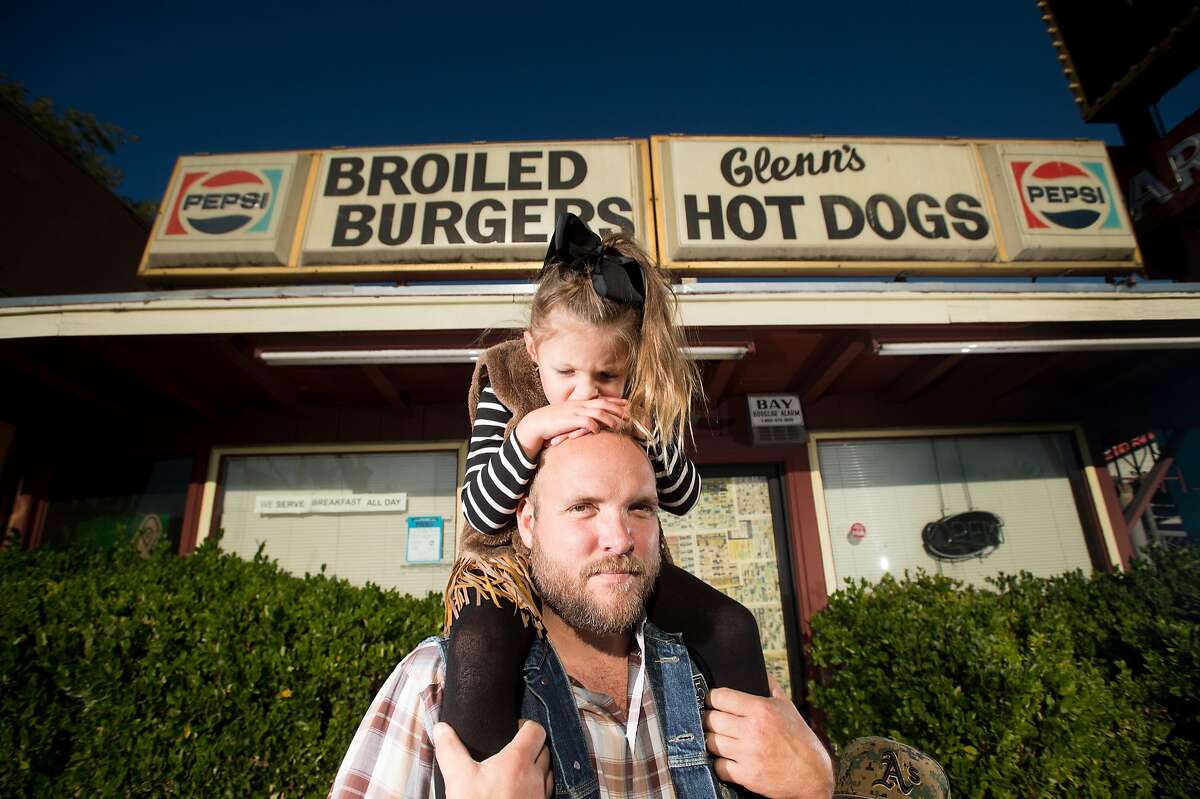 Ryan Farr, founder of 4505 Meats, stands with his daughter Scarlett Farr, 4, outside the future home of 4505 Burgers & BBQ in Oakland, Calif., on Monday, Oct. 10, 2016.