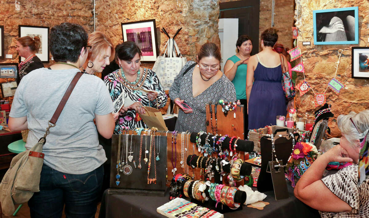 Shoppers browse the items available for sale during the Hecho a Mano Market at Gallery 201 on Friday afternoon.