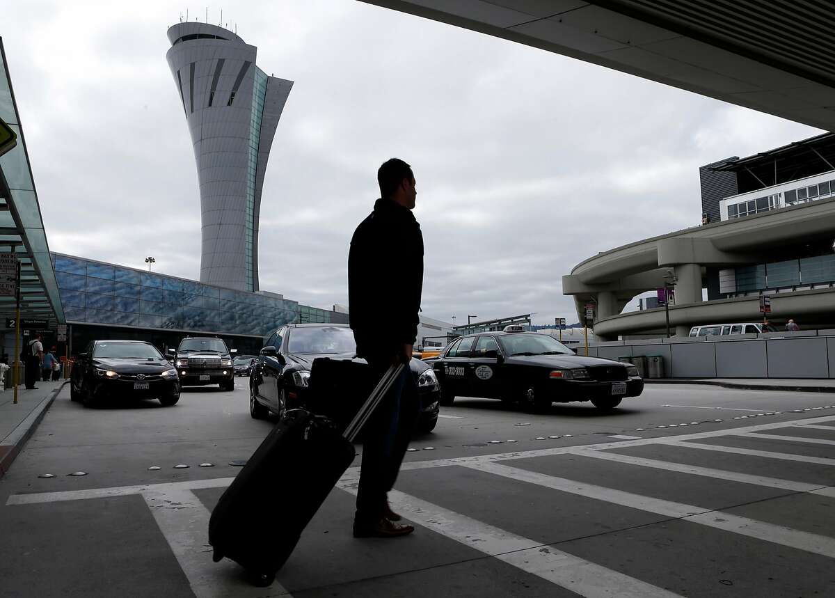 An arriving passenger walks past the new SFO air traffic control tower between terminals one and two in San Francisco, Calif. on Tuesday, Oct. 11, 2016. The iconic 221-foot tall FAA tower becomes fully operational Saturday.