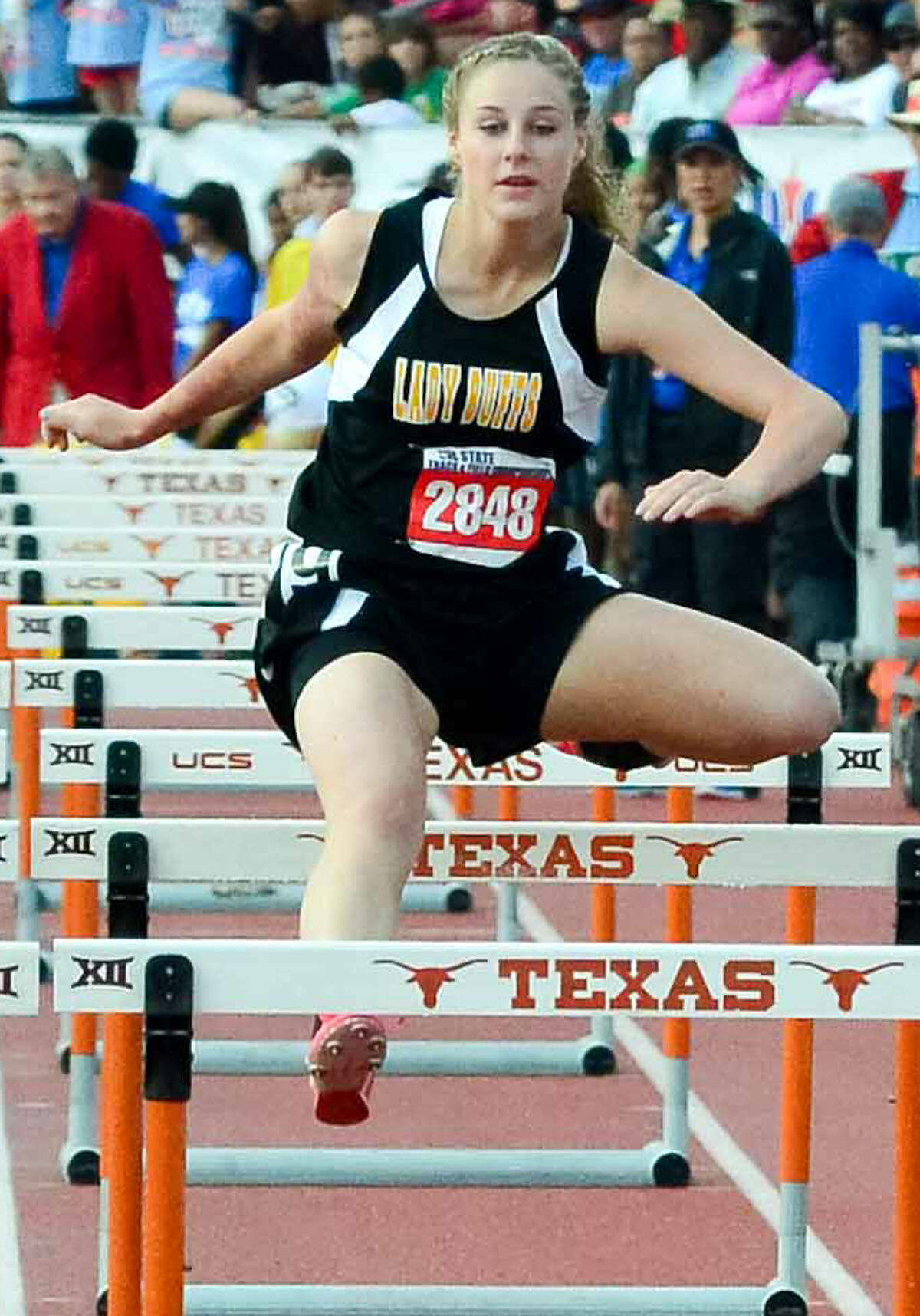 Petersburg freshman Morgan Byrd goes over a hurdle during the Class 1A 100-meter race at the UIL State Track and Field Championships in Austin Saturday.
