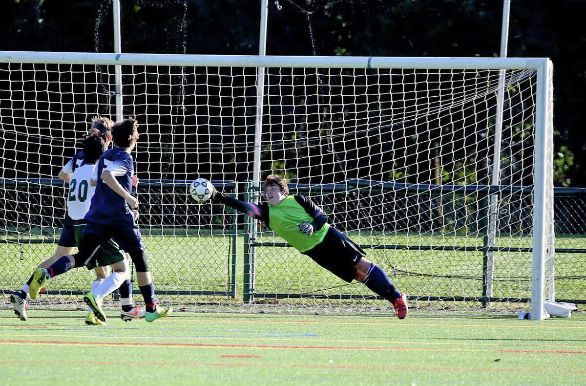 Greens Farms academy senior goalkeeper Gabe Durmoulin of Westport, makes a diving save in his team's 4-0 victory over Hamden Hall on Wednesday, Oct. 5. Durmoulin had six saves in the shutout.