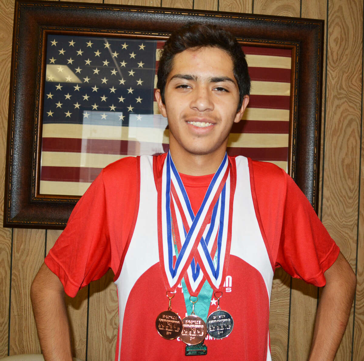 Plainview's Sergio Lara displays the medals he earned in two cross-country races in Australia last week. The Plainview High junior ran as part of the Down Under Sports program, which gives select high school athletes the chance to compete in their sport and learn about the Australian culture.