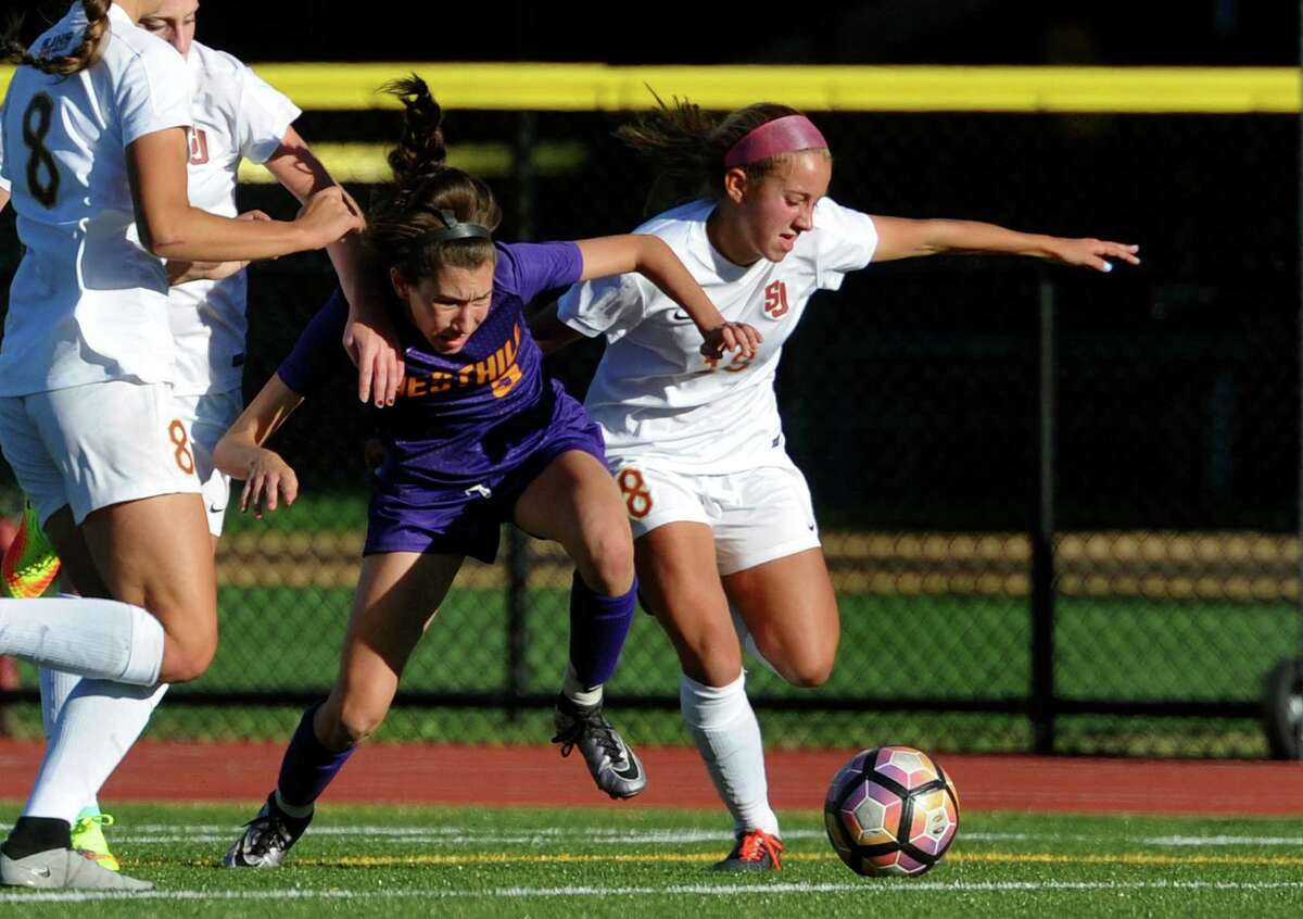 Westhill's Corrine Dente, center, and St. Joseph's Tory Bike, right, scramble for control of the ball during girls soccer action in Trumbull, Conn., on Tuesday Oct. 11, 2016.