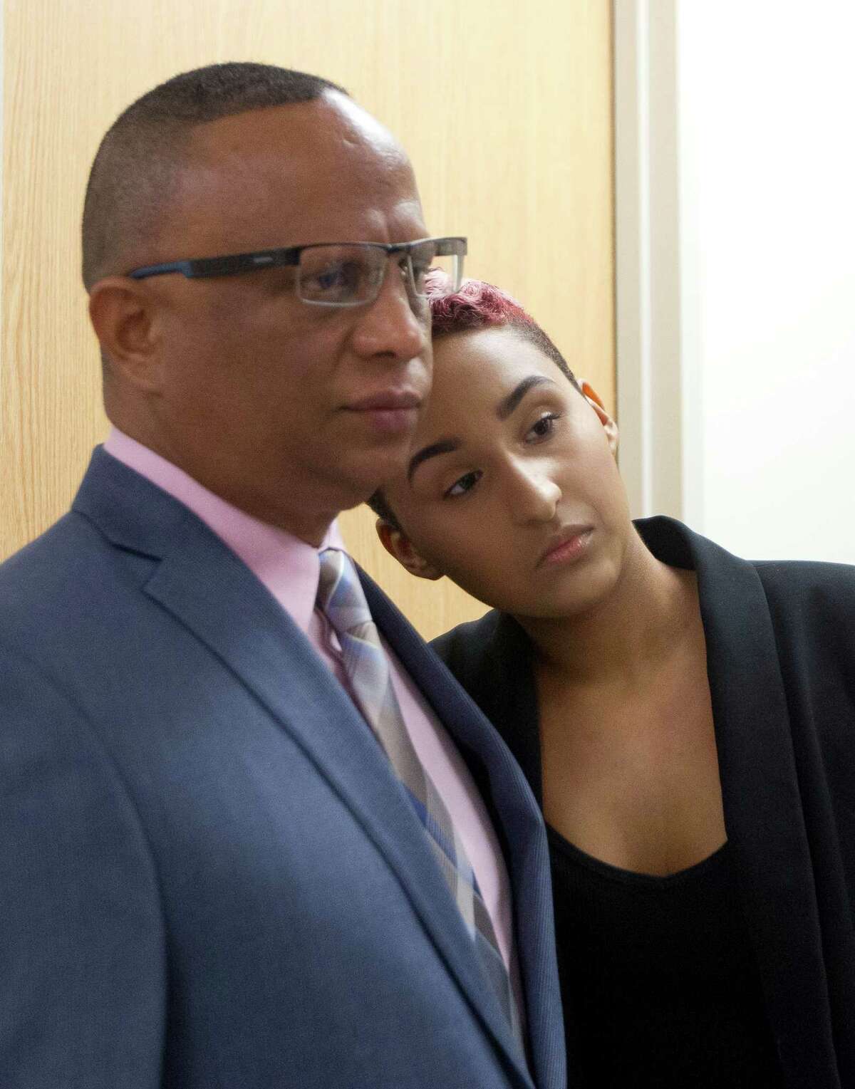 Mia Sosa, right, rests her head on the shoulder of her father Ramon as he speaks with the media following the sentencing of his wife Maria to 20 years in prison after pleading guilty to solicitation of murder Tuesday, Oct. 11, 2016, in the Lee G. Alworth building in Conroe.