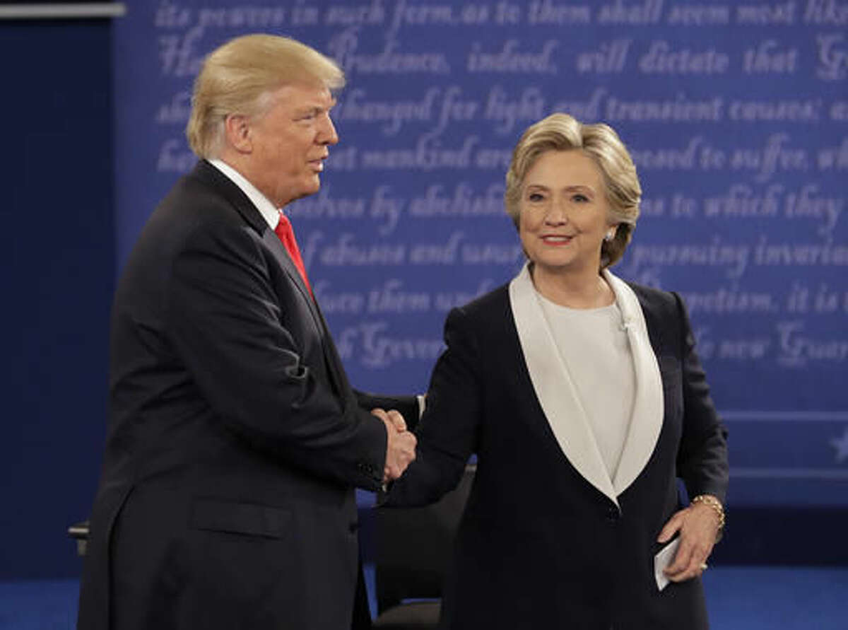 Republican presidential nominee Donald Trump shakes hands with Democratic presidential nominee Hillary Clinton during the second presidential debate at Washington University in St. Louis, Sunday, Oct. 9, 2016. (AP Photo/John Locher)