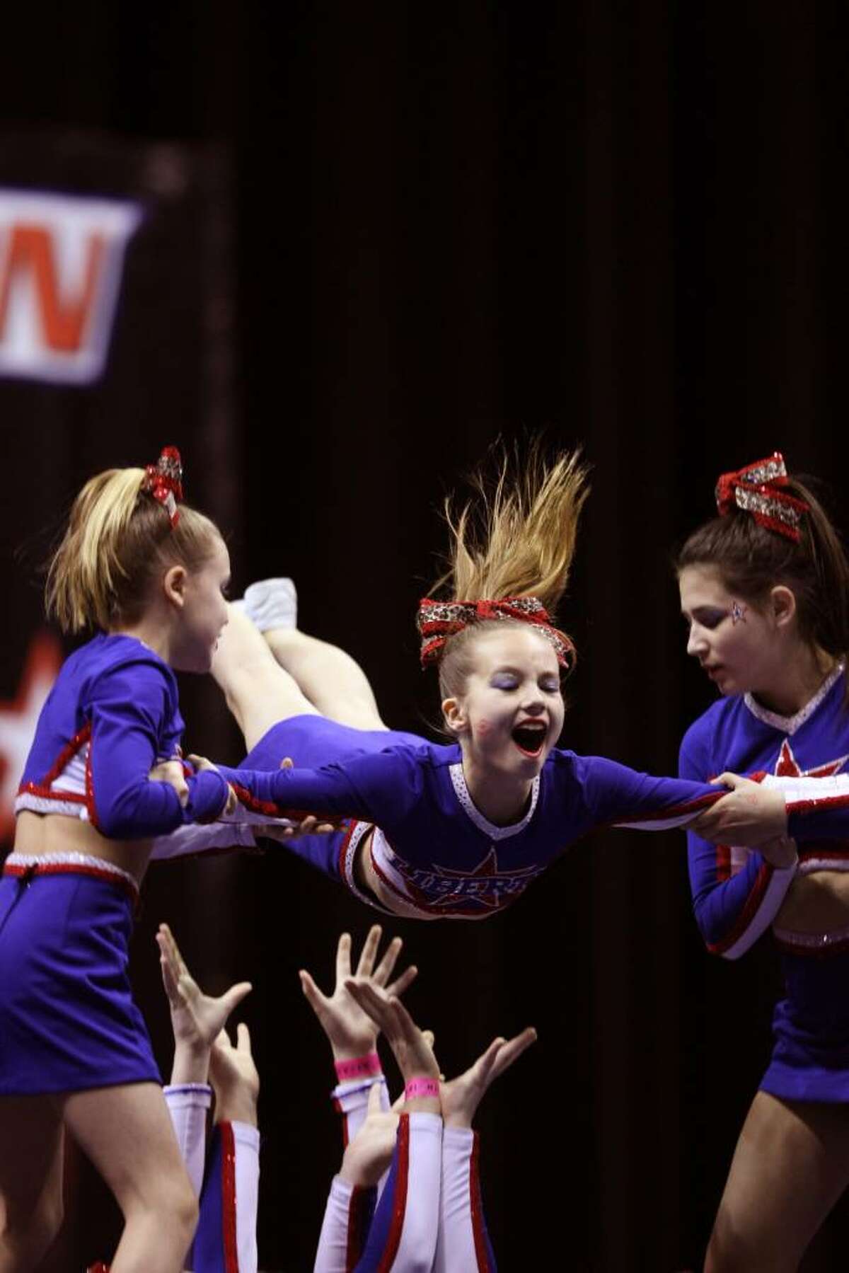 Liberty Senior Stars cheerleaders Erika Bloes, left, of Riverside, Shelby Hopper, center, of Riverside, and Amanda Friedlander, right, of Cos Cob, are captured in action in the center of the pyramid.