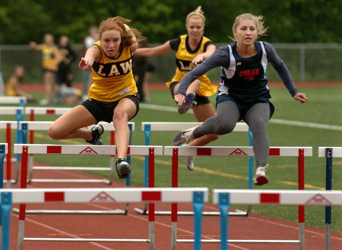 Jonathan Law's Kathleen Croke, left, and Foran's Caitlin Eccleston, battle it out in the 100 meter hurdles, during track action at Foran High in Milford, Conn. on Tuesday May 11, 2010. Essleston won the heat.