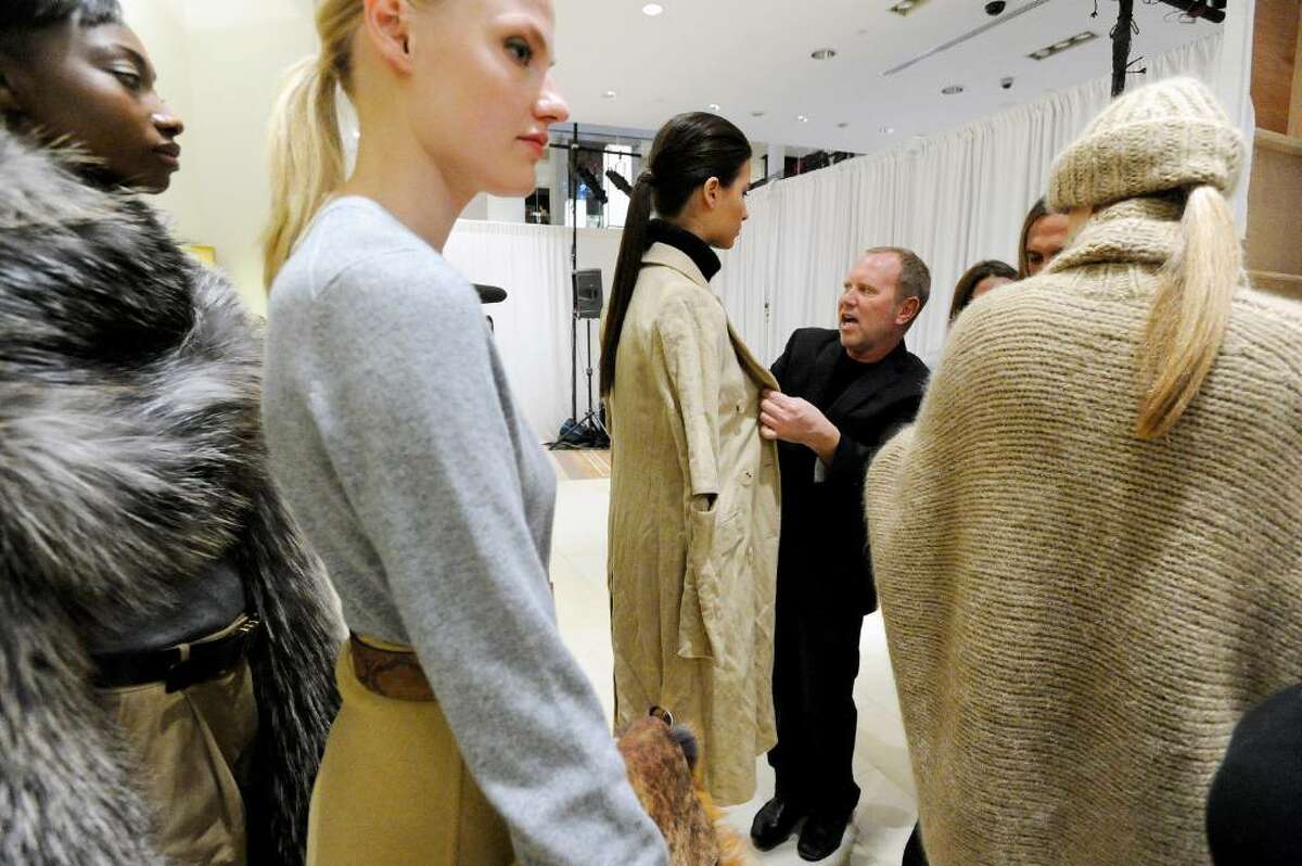 World-renowned designer Michael Kors looks the models over before the show as he recreates his Bryant Park Fashion Week 2010 show presenting his fall collection at Richards of Greenwich Tuesday, May 11, 2010. After the show Kors held a trunk show greeting flocks of shoppers. The trunk show will be hosted by Kors' associates at Richards running through Thursday and then move to Mitchells in Westport for Friday and Saturday.