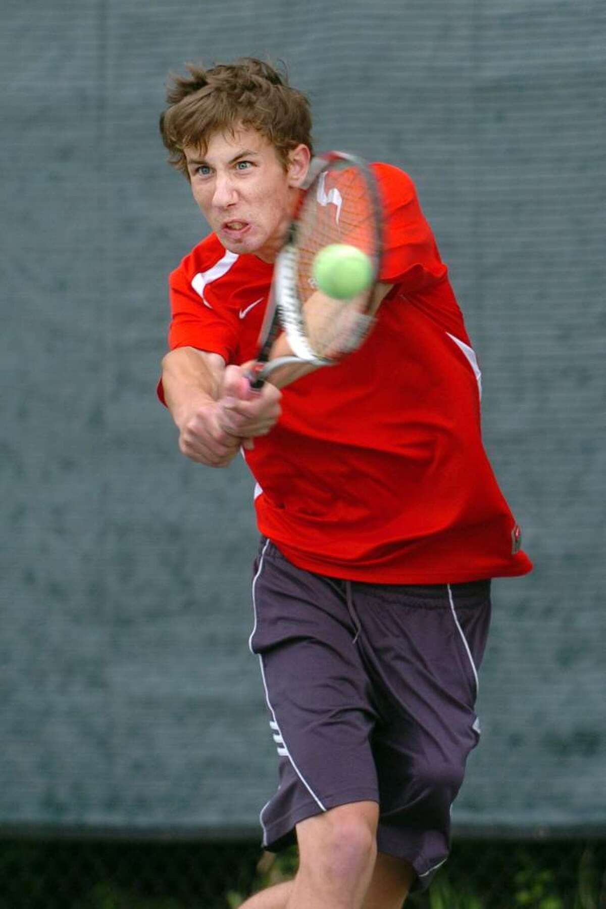 New Canaan's Kevin Budrawich returns the ball to Staples' Cam Marco during their match Tuesday May 11, 2010 in Westport.