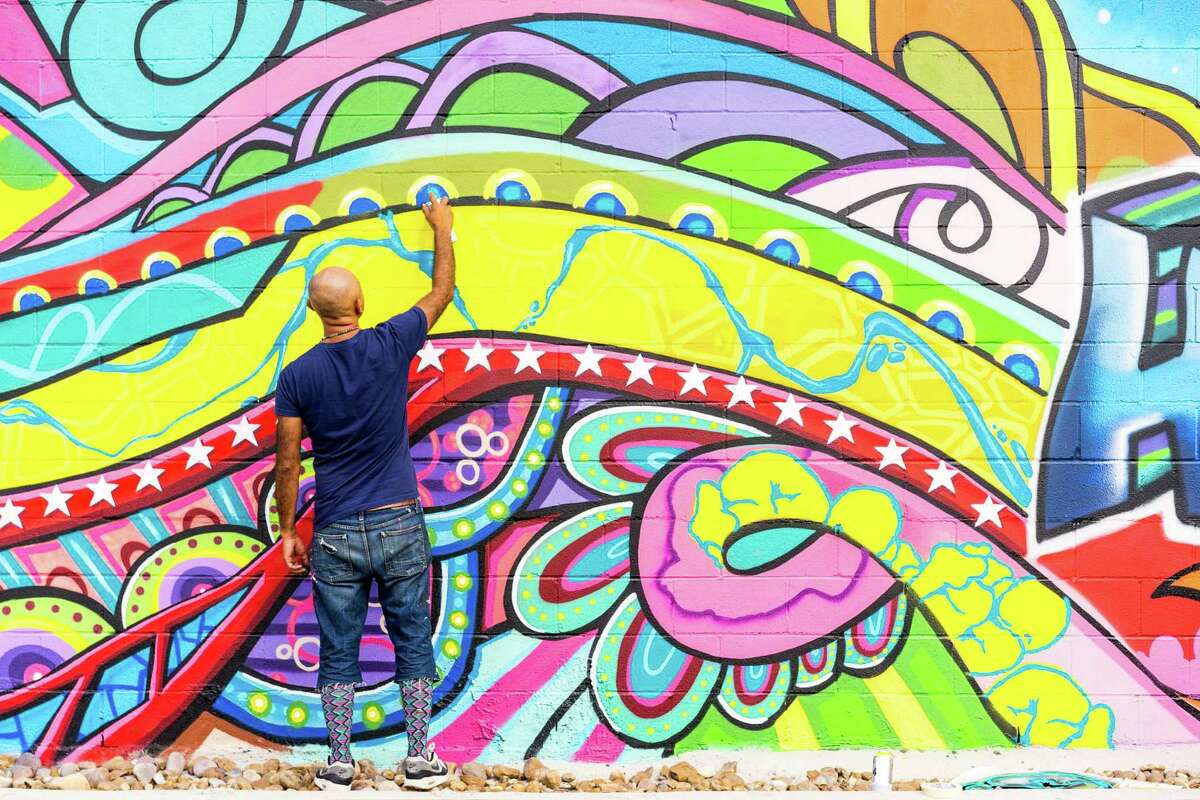 ﻿Gonzo is shown working on the large-scale mural he created in Market Square in 2013.
