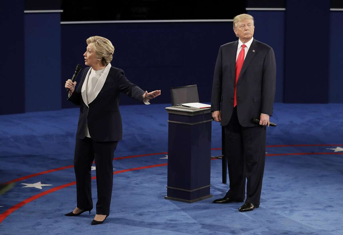 Republican presidential nominee Donald Trump listens to Democratic presidential nominee Hillary Clinton during the second presidential debate at Washington University, Sunday, Oct. 9, 2016, in St. Louis. (AP Photo/John Locher)