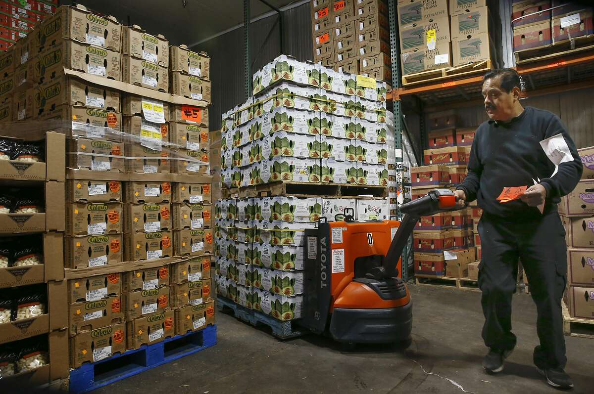 Lorenzo Dominguez moves a pallet of avocados inside the distribution warehouse at Pacific Produce in South San Francisco, California. on Wednesday October, 12 2016