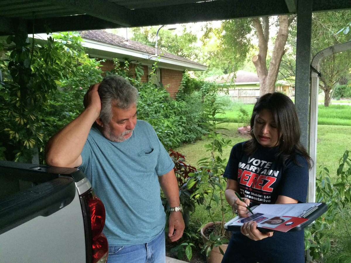 Mary Ann Perez, Democratic candidate for Texas House District 144, talks with voter Felipe Zavala, 65, as she knocks on doors along a residential block in Pasadena, Wednesday, Sept. 28, 2016. Zavala said he is a Republican but will join his Democrat wife and daughter in opposing GOP nominee Donald Trump. Andrew Kragie / Houston Chronicle