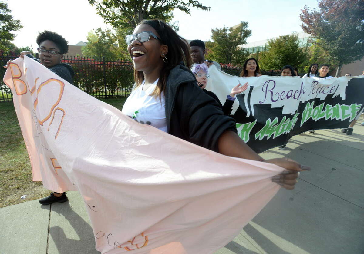 Mashiy Harris-Tate, a junior at Bassick High School, calls to drivers to honk their horns as she marches with other area students Saturday, Oct. 24, 2015, during the 10th annual March Against Violence through downtown Bridgeport, Conn. The march started to honor the life of Bassick High School junior Tavon DuHarte who was murdered in 2006. Bassick teacher Jennifer Bosques, who has organized the event for the past nine years, said that the march "is still necessary, still relevant," ten years later. As the community mourns the death of another Bassick junior, Jevon Setal who was killed on September 29 in a drive-by shooting, she hopes this year's march can be used as "a platform for healing."