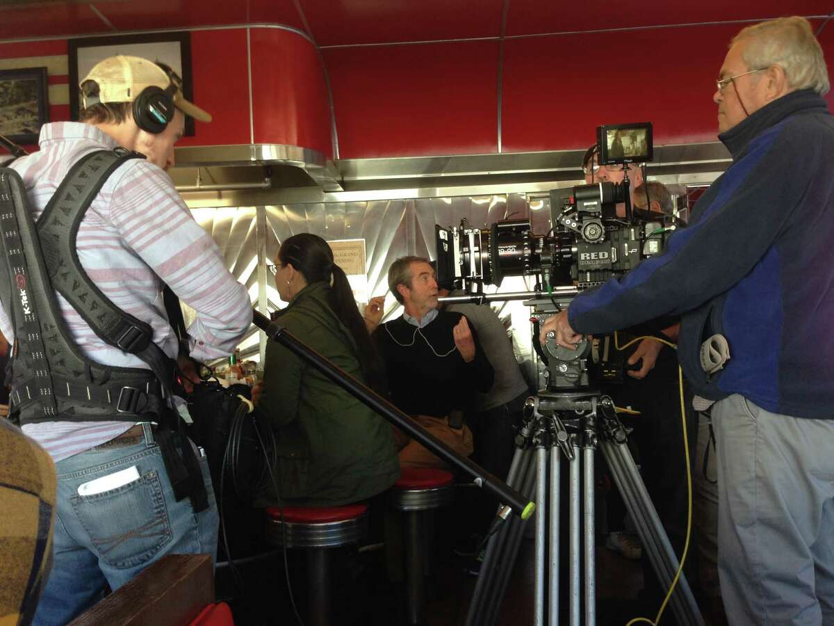 Director David Jackson, center, and cameraman Denis Maloney, director of photography, right, shooting "Derailed" at Jack's Diner in Albany (photo by Amy Biancolli)