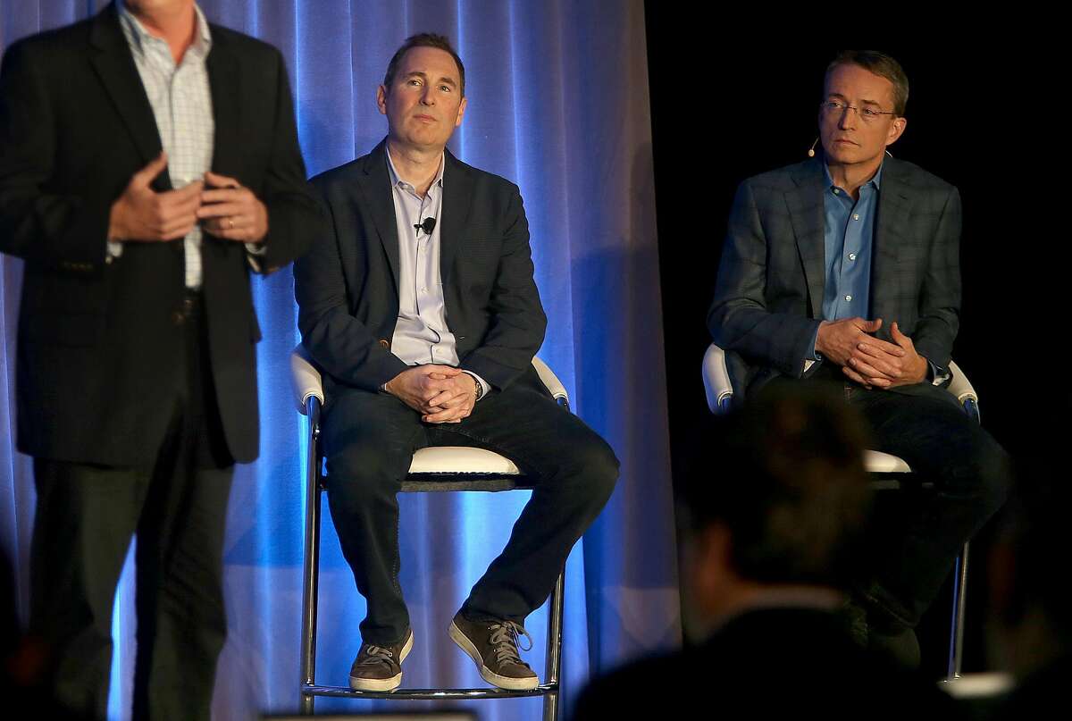Western Digital CIO Steven Phillpott (left) speaks with CEO Andy Jassy (middle) and VMware CEO Parick P. Gelsinger (right) during a press conference announcing Amazon's cloud service, AWS, partnering with VMware Cloud creating a new integrated cloud service on Thursday, October 13, 2016, in San Francisco, Calif.