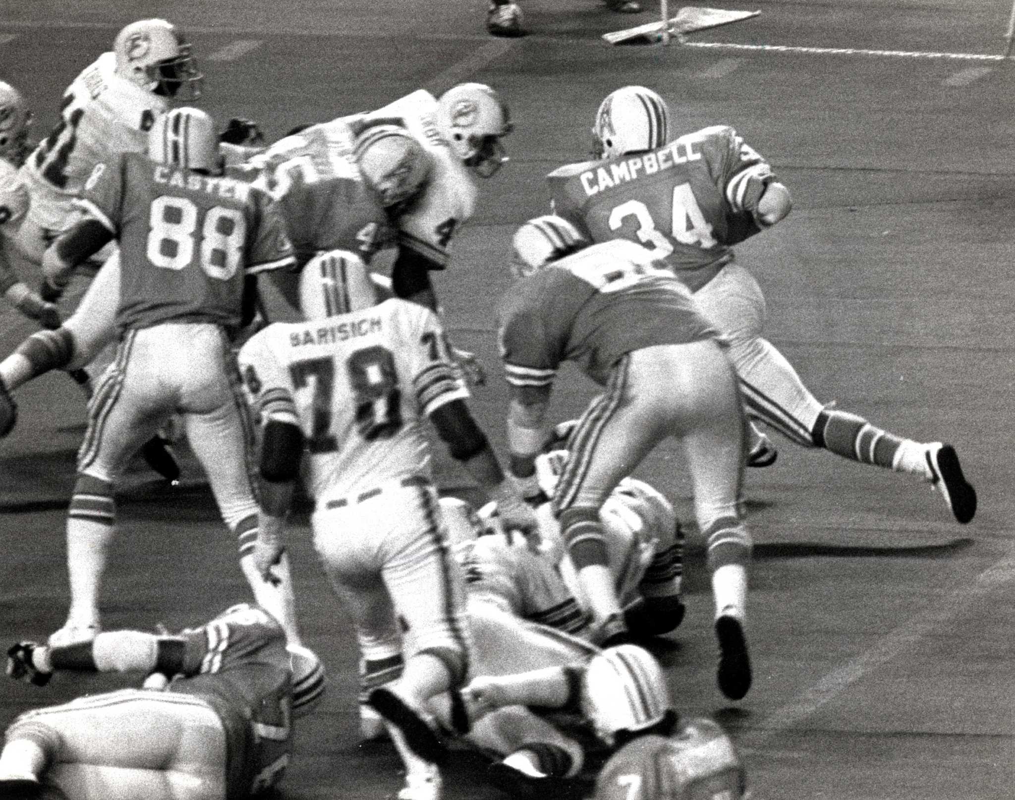 Running back Earl Campbell of the Houston Oilers is tackled by