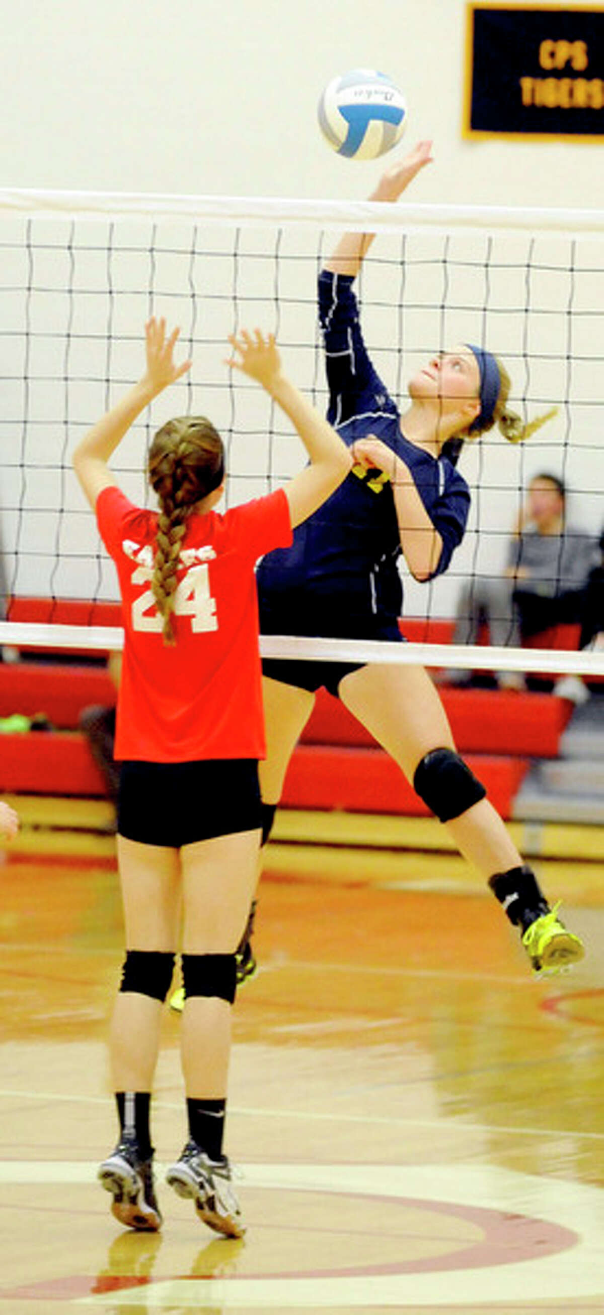 North Huron's Lauren Schornack (11) leaps for a kill against Caseville's Allison Smith (24) during the first set.