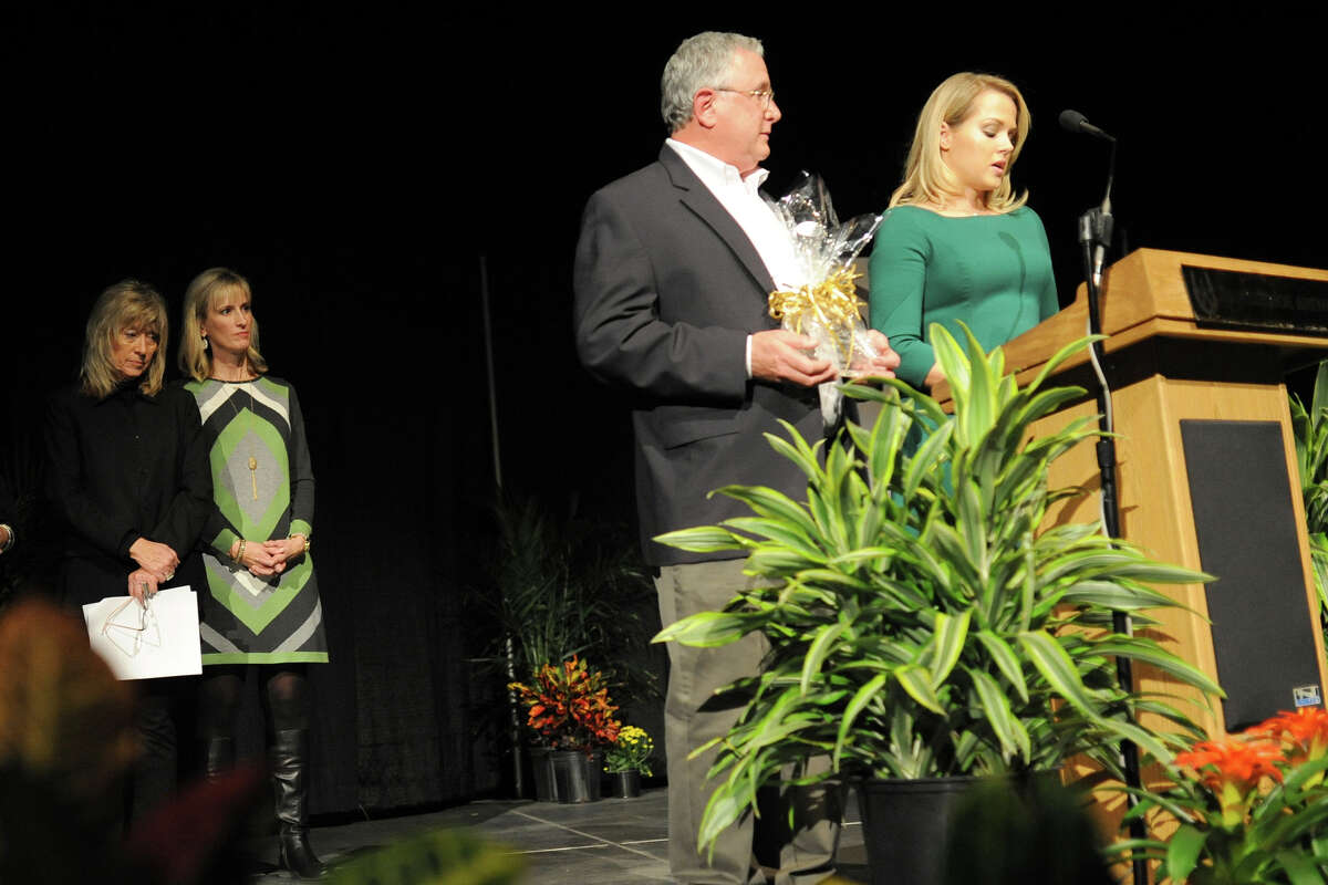 Gary Elander, a member of the Habitat for Humanity Board of Directors, presents the Mark B. Merritt Golden Hammer Award to Concho Resources, represented by Kristin Ditto, during the Habitat For Humanity fundraiser Thursday, Oct. 13, 2016, at Horseshoe Arena. Marcus Luttrell, former Navy SEAL and author of "Lone Survivor," was the guest speaker at the fundraiser. James Durbin/Reporter-Telegram