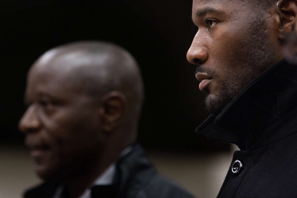 Former Seahawks fullback Derrick Coleman, right, listens to his father, Derrick Coleman Sr., speak to the court during his sentencing for felony hit-and-run and vehicular assault, in Seattle on Friday, Oct. 14, 2016.