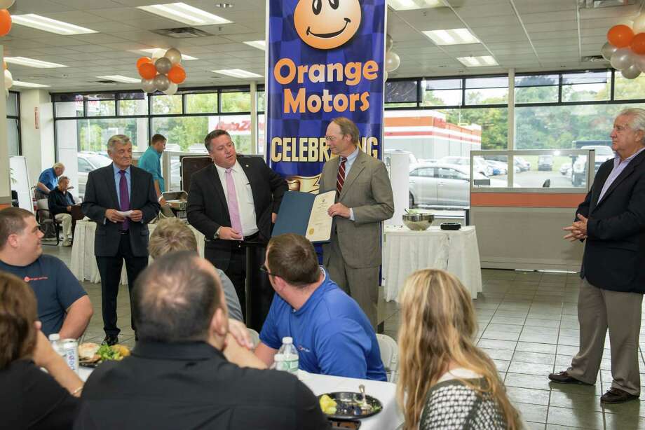 Orange Motors celebrating its 100th anniversary back in 2016. Above, from left, then-general manager Carl Keegan, who had been with the dealership for 45 years, Albany County Executive Dan McCoy, dealership owner Charles Touhey, and former Albany Mayor Gerald Jennings.&nbsp;