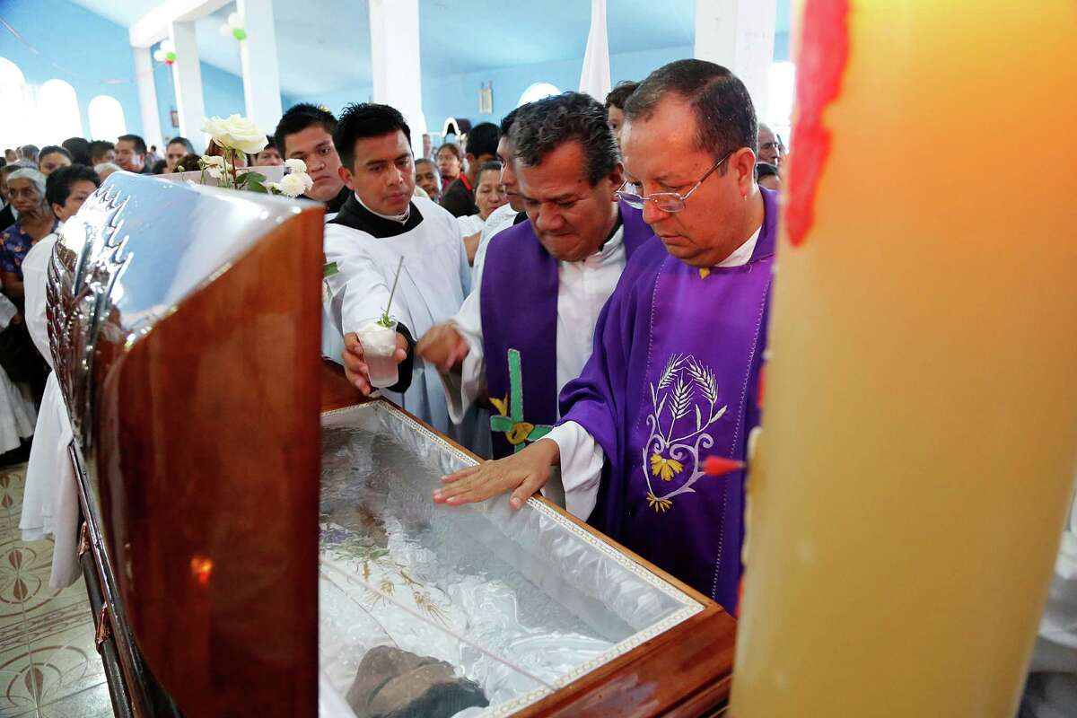 Priests pay their respects last month to Rev. Jose Alfredo Suarez de la Cruz, one of 15 clergymen killed in Mexico in the past four years.