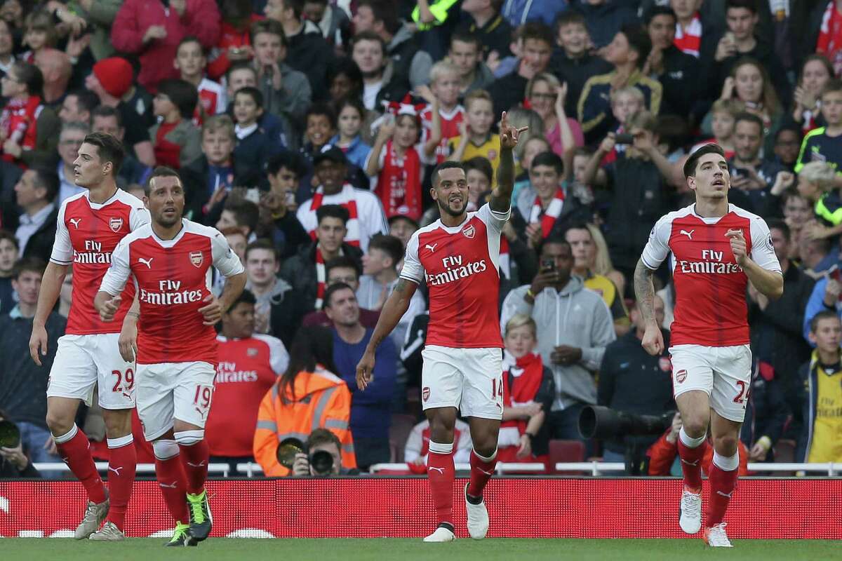 Arsenal's Theo Walcott celebrates after scoring his team's first goal during the English Premier League soccer match between Arsenal and Swansea City at The Emirates Stadium in London, Saturday Oct. 15, 2016. (AP Photo/Tim Ireland)