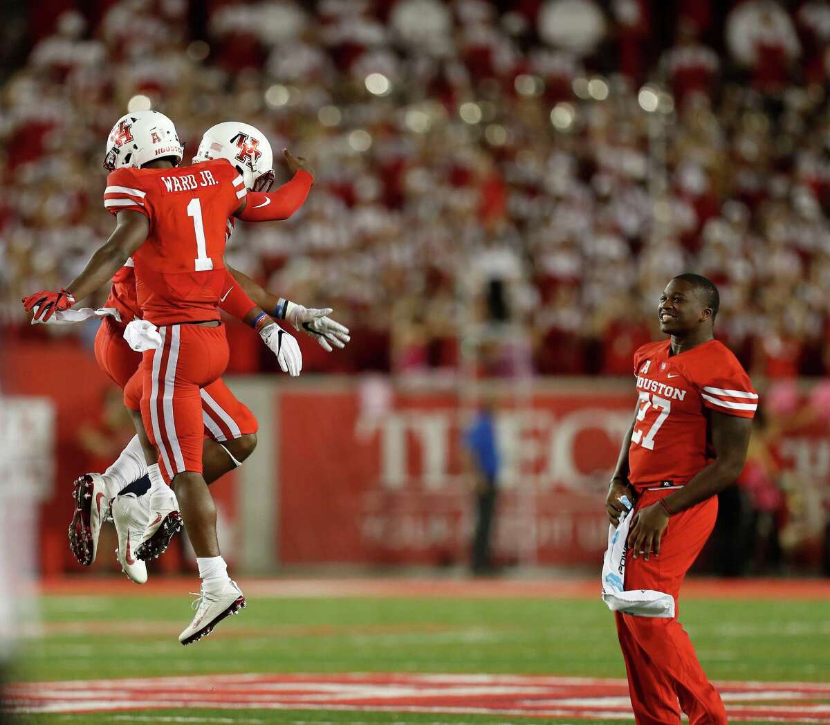 Houston Cougars safety Austin Robinson (22) and quarterback Greg Ward Jr. (1) celebrate after Robinson stopped Tulsa Golden Hurricane defensive tackle Jesse Brubaker (8) at the goal line in the final seconds of a tied game during the second half of an NCAA college football game at TDECU Stadium, Saturday,Oct. 15, 2016 in Pearland.
