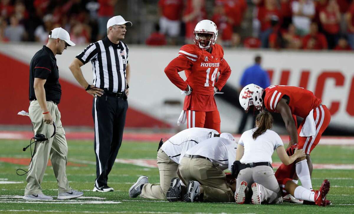 Houston Cougars quarterback Greg Ward Jr. (1) checks on wide receiver Chance Allen (21) who was injured during the second half of an NCAA college football game at TDECU Stadium, Saturday, Oct. 15, 2016.