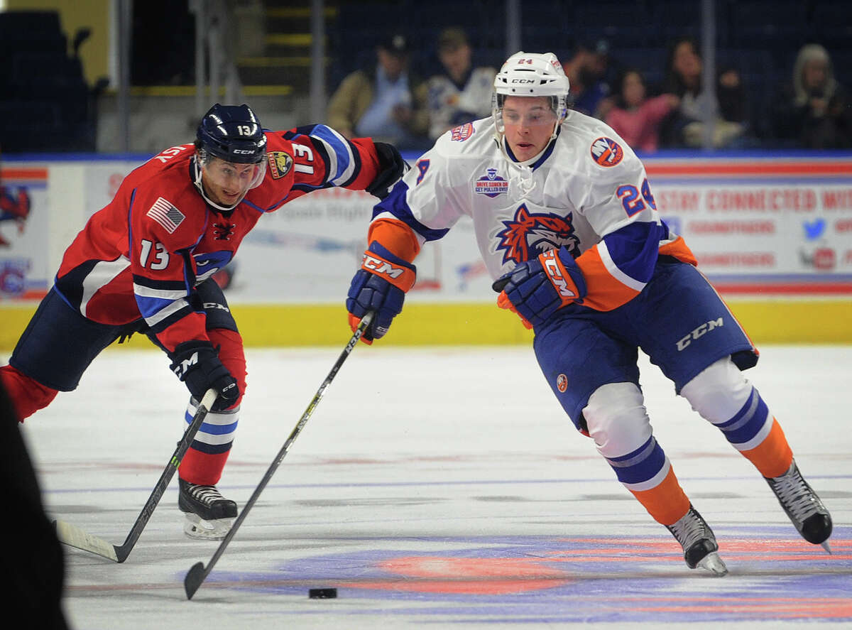 Sound Tiger Travis St. Denis races the puck up ice ahead of Springfield defender Chase Balisy in the first period of their AHL hockey game at the Webster Bank Arena in Bridgeport on Sunday.