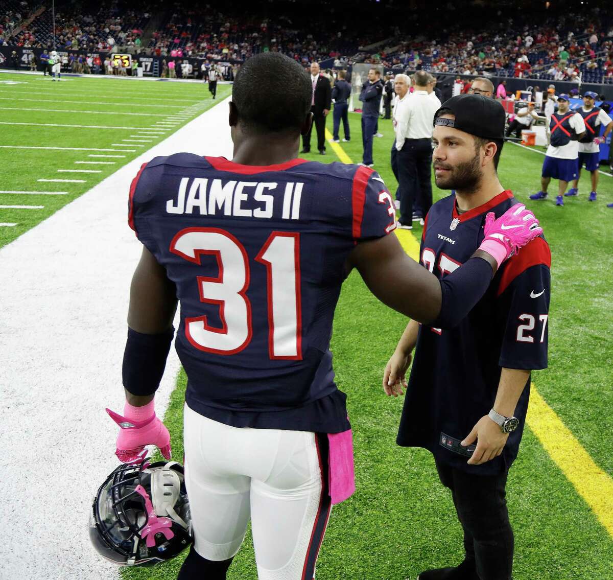 Houston Astros second baseman Jose Altuve chats with Texans defensive back Charles James (31) before the start of an NFL football game at NRG Stadium, Sunday,Oct. 16, 2016 in Houston.