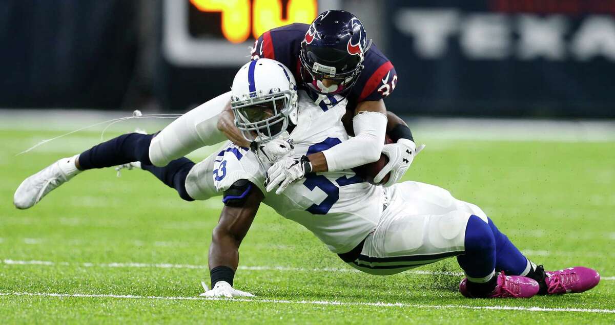 Houston Texans cornerback Kevin Johnson (30) stops Indianapolis Colts running back Robert Turbin (33) during the second quarter of an NFL football game at NRG Stadium on Sunday, Oct. 16, 2016, in Houston.