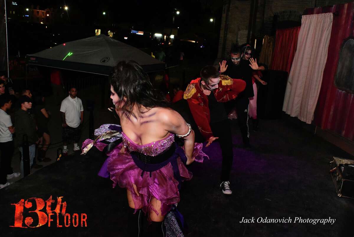 Crowds of cowering Halloween adventurers poured onto the grounds of the 13th Floor Haunted House, where creepy creatures lurk every corner, for a monster bash on Oct. 15, 2016.