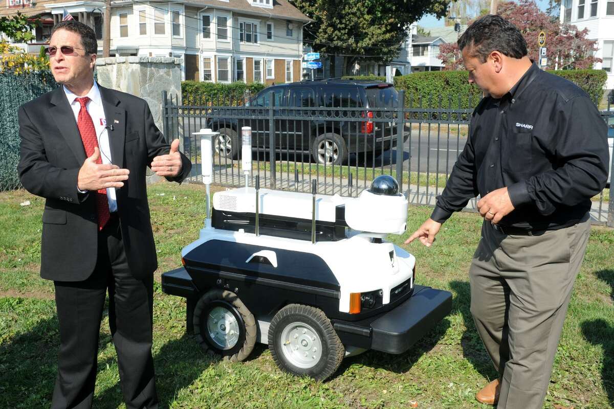 David Antar, President of A+ Technology & Security Solutions, left, and David Lewis of Sharp Robotics Business Development answer questions at the unveiling of the Sharp INTELLOS, an Automated Unmanned Ground Vehicle in Bridgeport, Conn. Oct. 17, 2016.