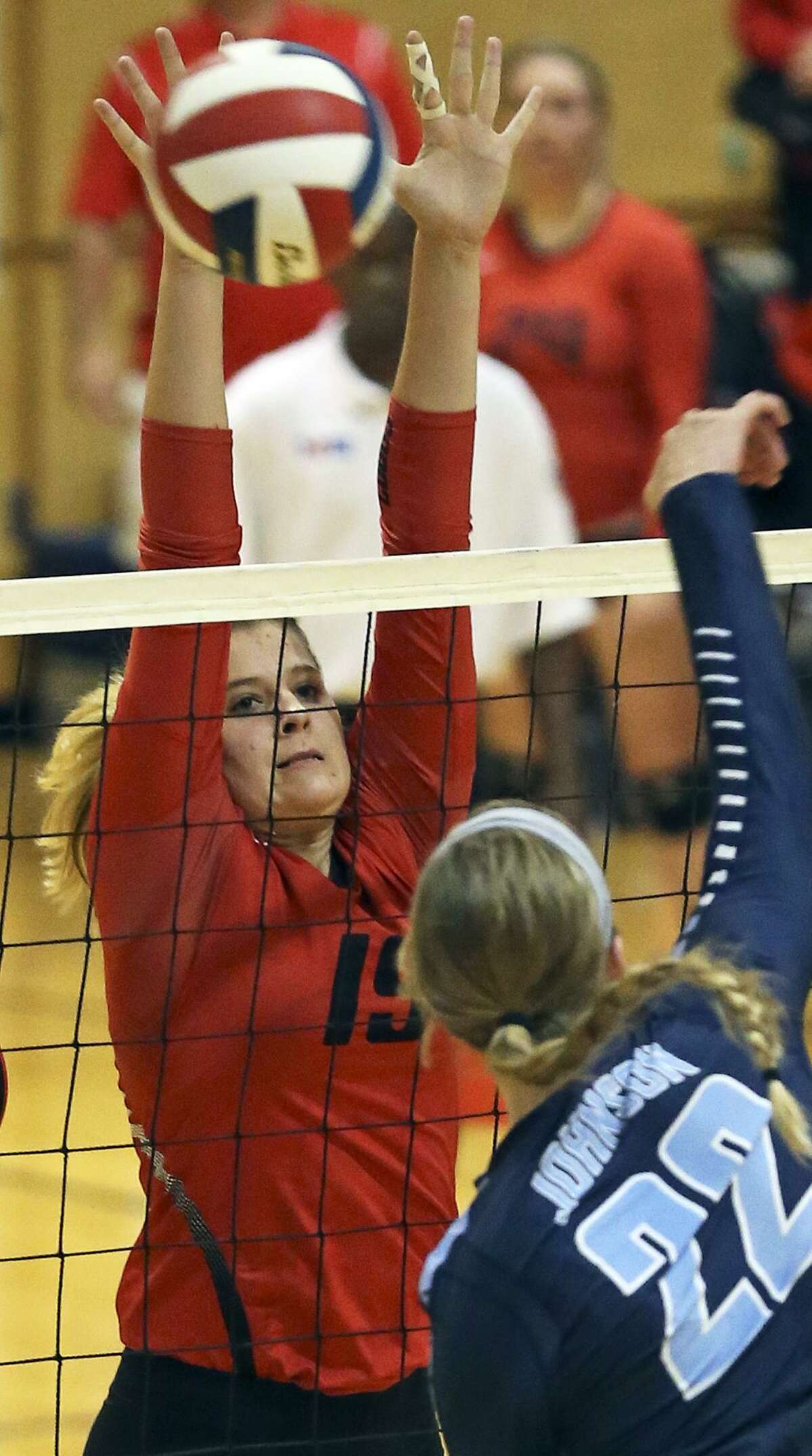 Brooke Vestal goes up for a block as New Braunfels Canyon beats Johnson 3-1 to advance to the Class 6A regional tournament on Nov. 10, 2015.
