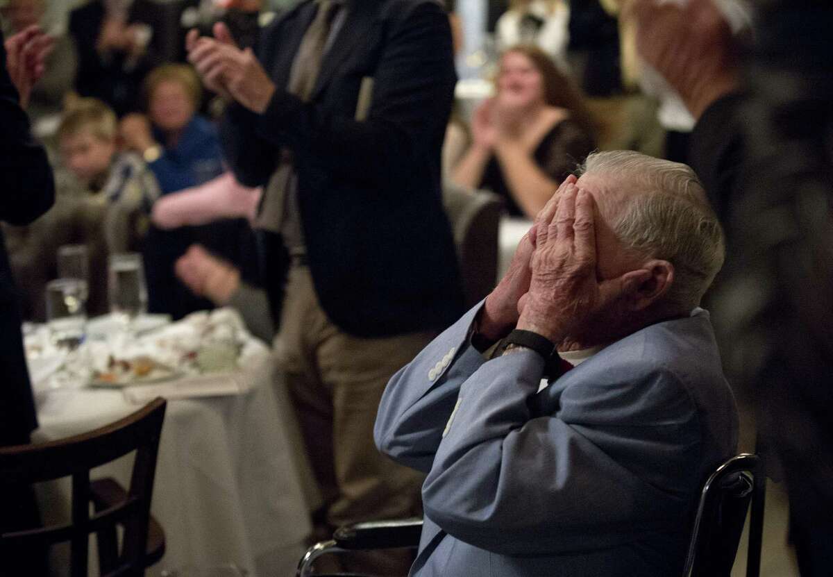 Former baseball coach Tom Deneen is overcome with emotion as he gets a standing ovation after being inducted into the Greenwich High Hall of Fame at the Greenwich Water Club on Saturday, October 15, 2016.