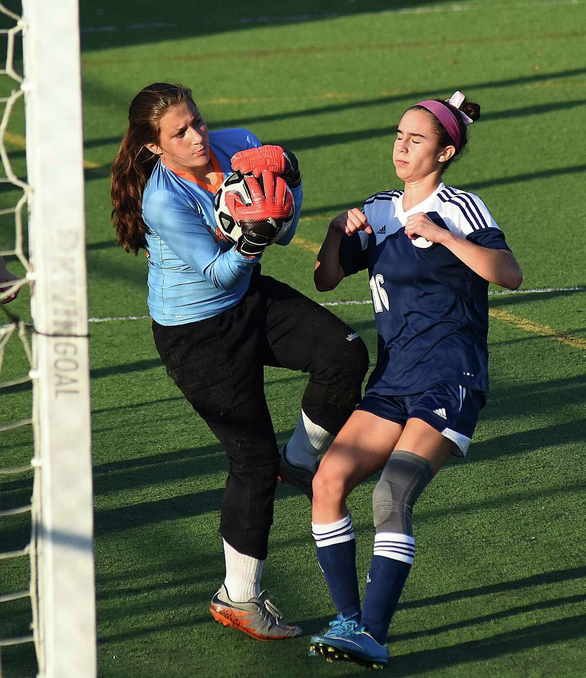 Stamford freshman goalkeeper Adriana Deltorto, left, makes a save as Wilton’s Carly Lattimer crashes the net during Monday’s FCIAC girls soccer game in Stamford. Wilton won, 3-0.