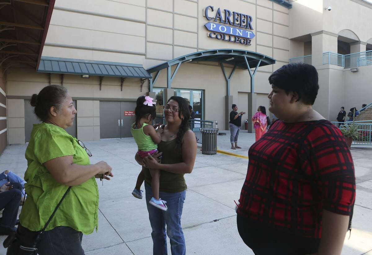 Former Career Point College students Rose Costello (left), Melanie Mireles (center), and Marianna Perez (right) stand outside of the school Monday October 17, 2016 after the for-profit school shut its doors. A letter sent to students and teachers from its president and CEO said the school is shutting its doors after management discovered that three long-term employees had "collaborated to violate the rules related to student aid funds." The school was located at the Wonerland of the Americas Mall.