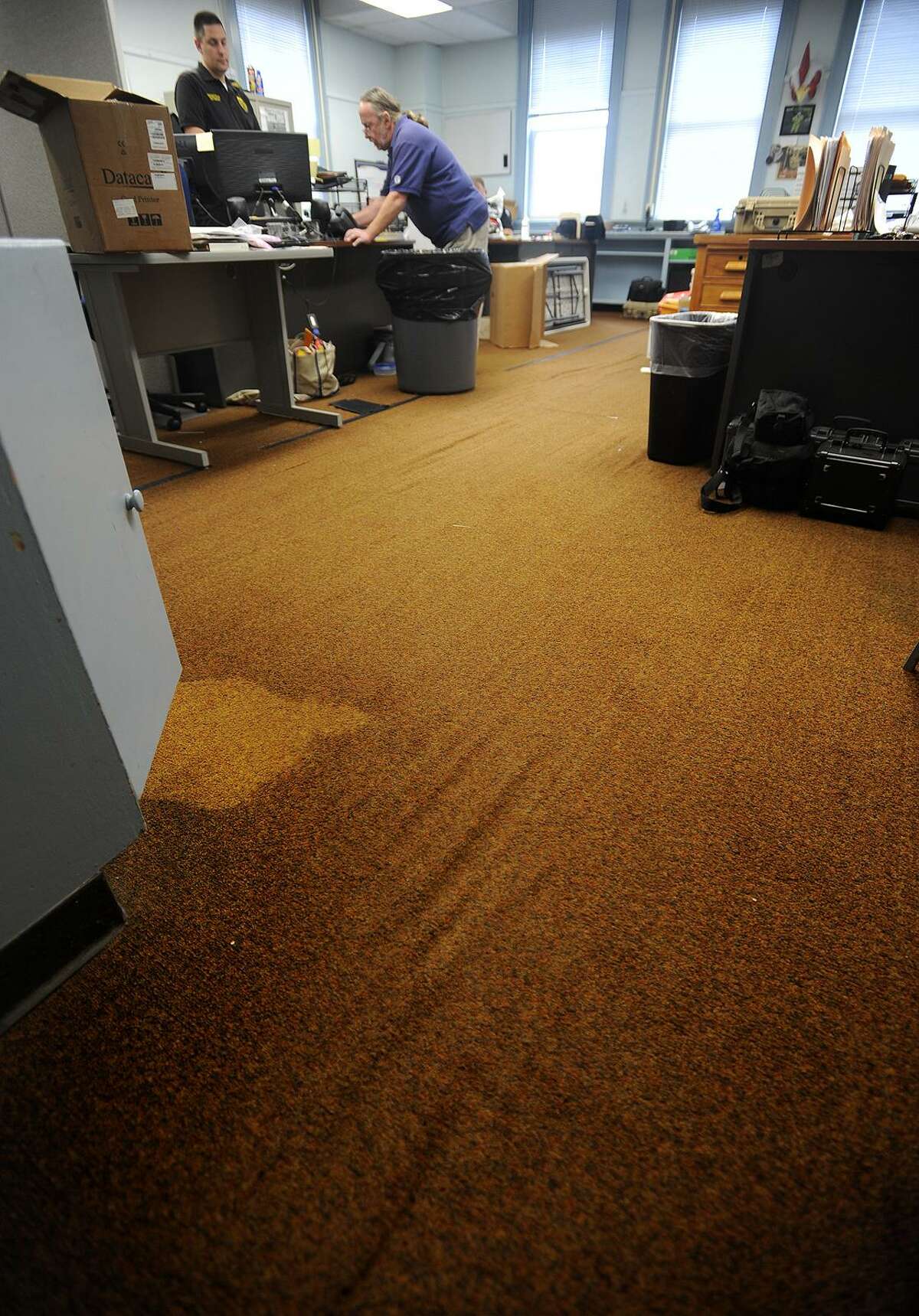 Old rug creates a tripping hazard in the detectives' room at the police station in Ansonia, Conn. on Thursday, October 13, 2016. Ansonia voters are being asked to approve $12 million in bonding for the construction of a new police station.