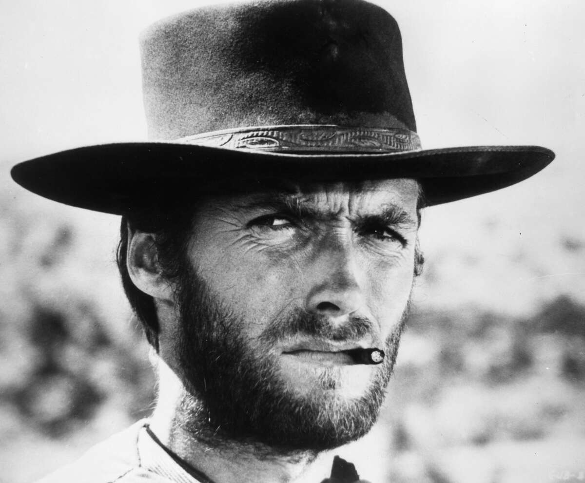 1966: American actor Clint Eastwood squints while smoking a cigarette between his teeth in a still from director Sergio Leone's film 'The Good, The Bad, and The Ugly.' Eastwood wears a wide-brimmed leather hat. (Photo by Hulton Archive/Getty Images)