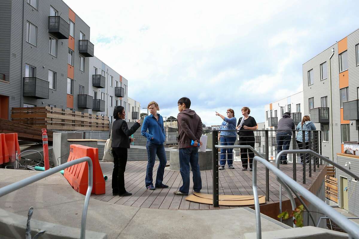 Potential buyers look over the public space that is in construction at the Shipyard, a large new housing development on former Hunters Point Naval Shipyard, on Saturday Oct 15, 2016 in San Francisco, Calif.