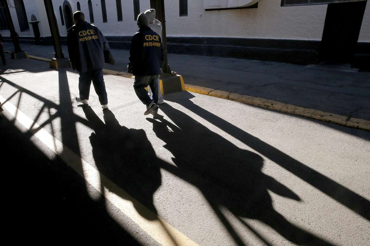 Prisoners walk through the grounds of the prison near death row at San Quentin State Prison on Tuesday December 29, 2015, in San Quentin, Calif.