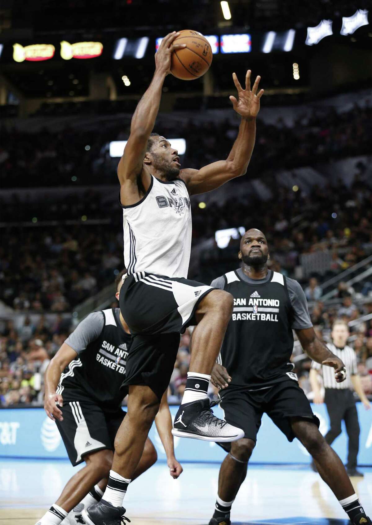 Kawhi Leonard goes up for a shot against Joel Anthony (right) during the Spurs’ Silver and Black open scrimmage at the AT&T Center on Tuesday, Oct. 18, 2016. (Kin Man Hui/San Antonio Express-News)