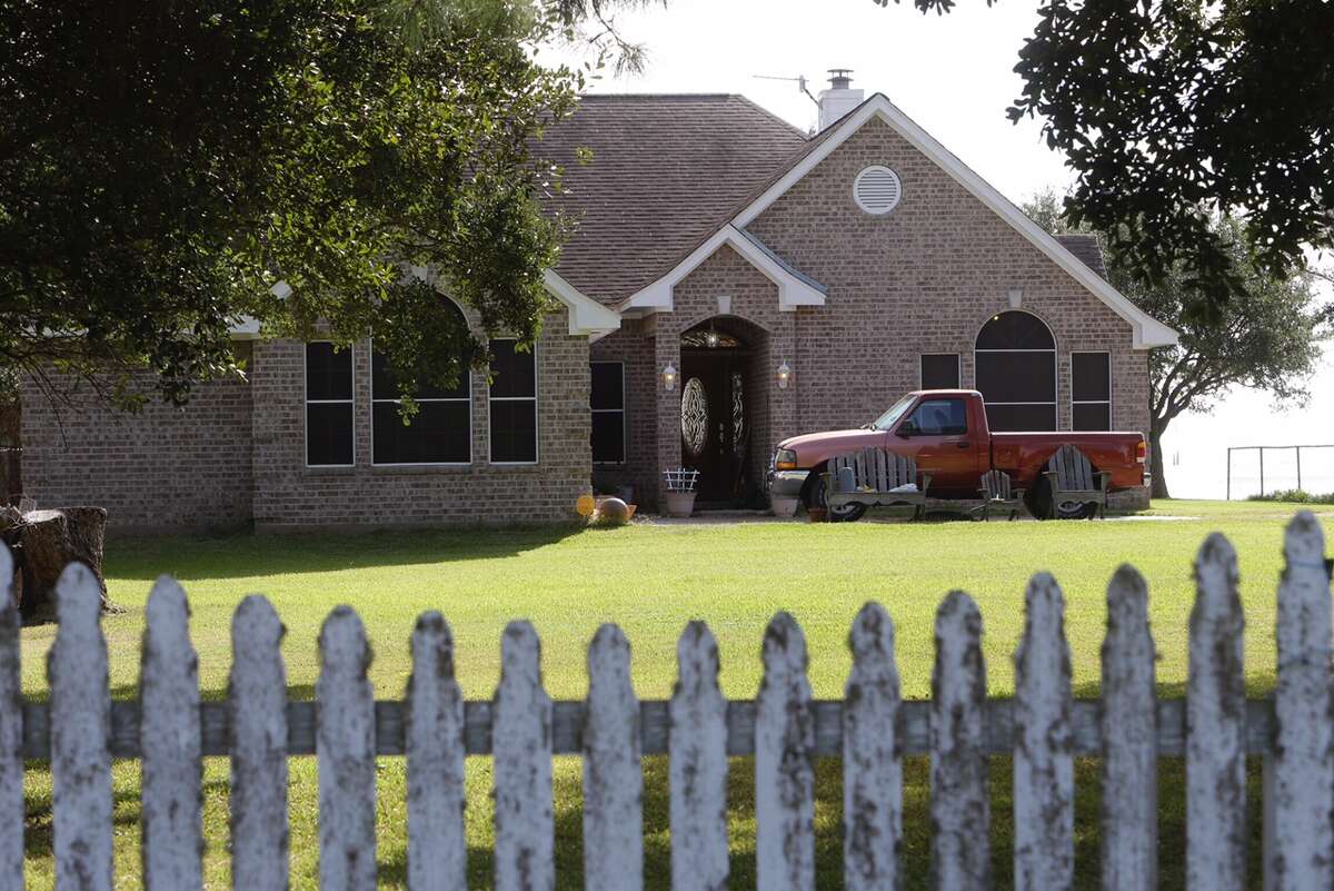 Police are seen at a home in the 11400 block of Cedar Gully Road in Beach City, Texas on Oct. 19, 2016. A man and woman in their 70s were found murdered in their bed the night before. The couple's 14-year-old grandson is a person of interest in the case.