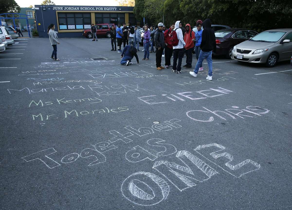 Students and faculty leave messages of support written in chalk at June Jordan School for Equity in San Francisco, Calif. on Wednesday, Oct. 19, 2016, following a shooting that wounded four students after school Tuesday.