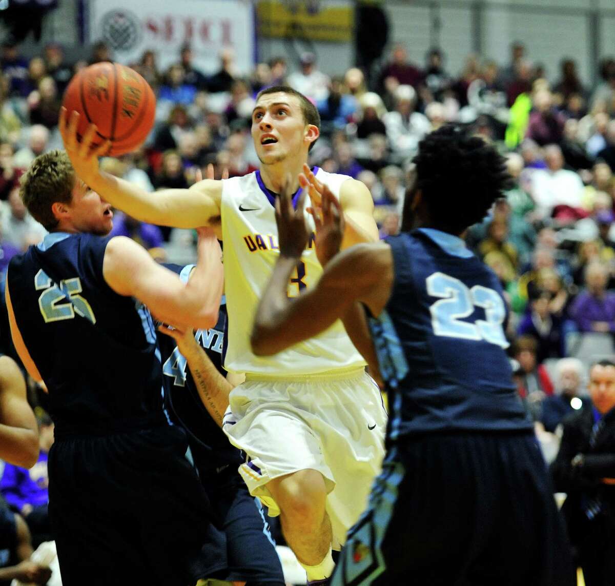 Joe Cremo of the UAlbany drives to the basket through two Maine players during their game on Sunday, Feb. 14, 2016, in Albany, N.Y. (Paul Buckowski / Times Union)